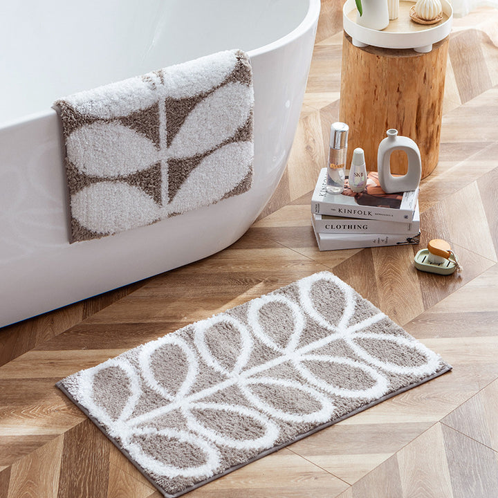 Fluffy bath mat in a graphic wave relief with anti-slip base