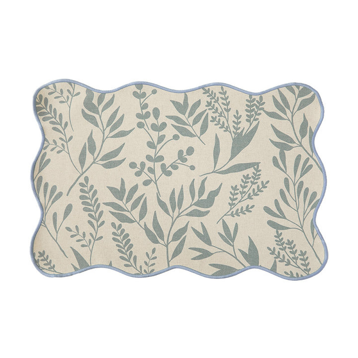 Shaped placemat made of cotton-linen with wavy edge and leaf pattern