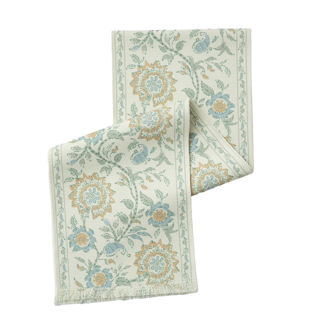 Vintage-inspired woven table runner with floral border and fringes
