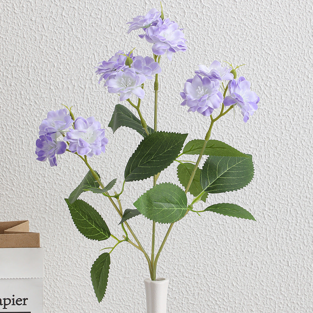 Artificial flower arrangement with delicate white blooms
