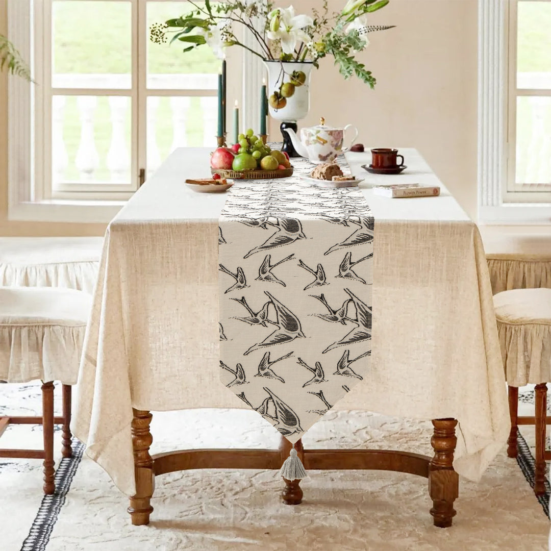 Woven double-sided linen table runner with tassels and hand-drawn swallow print