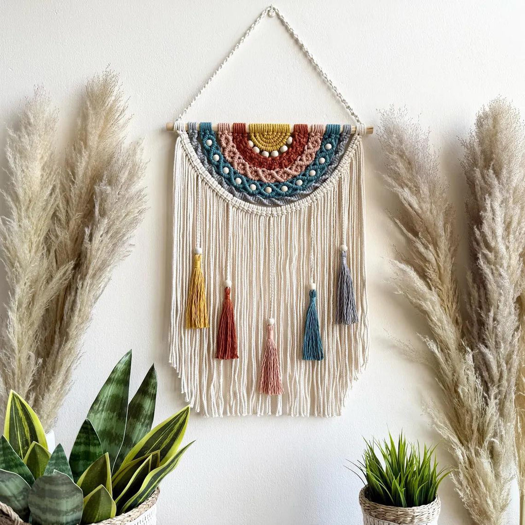 Artistic macrame wall hanging with colorful tassels and decorative elements