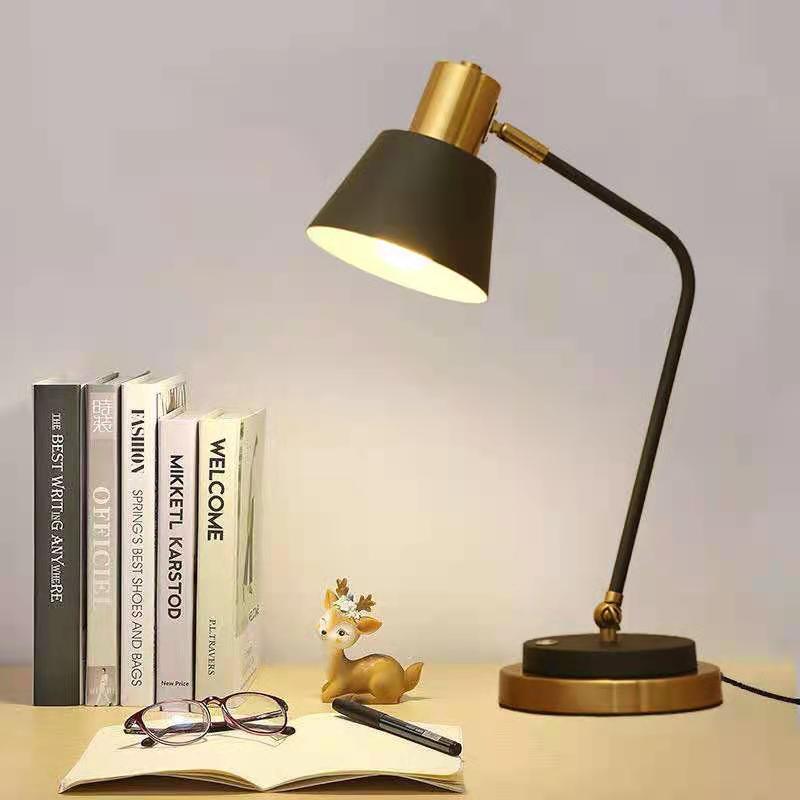 Adjustable metal desk lamp with swivel arm and brass accents