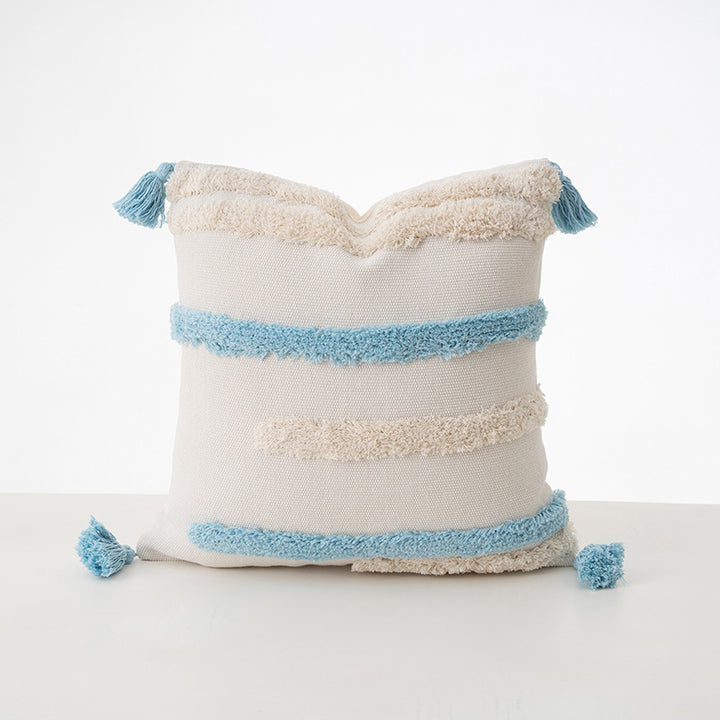 Square decorative cushion with boucle stripes, woven texture, and corner tassels