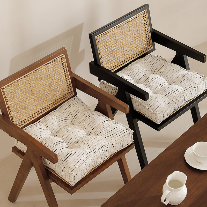 Padded square seat and floor cushion with quilted tufted padding and carrying handle