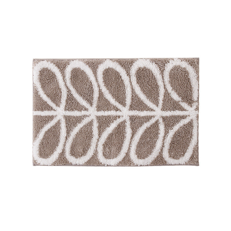 Fluffy bath mat in a graphic wave relief with anti-slip base
