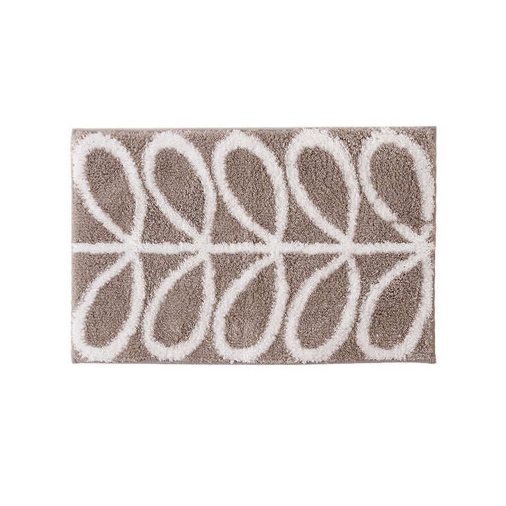 Fluffy bath mat in a graphic wave relief with anti-slip base