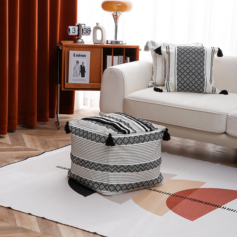 Braided square floor seat pouf with tassels and woven ethnic pattern