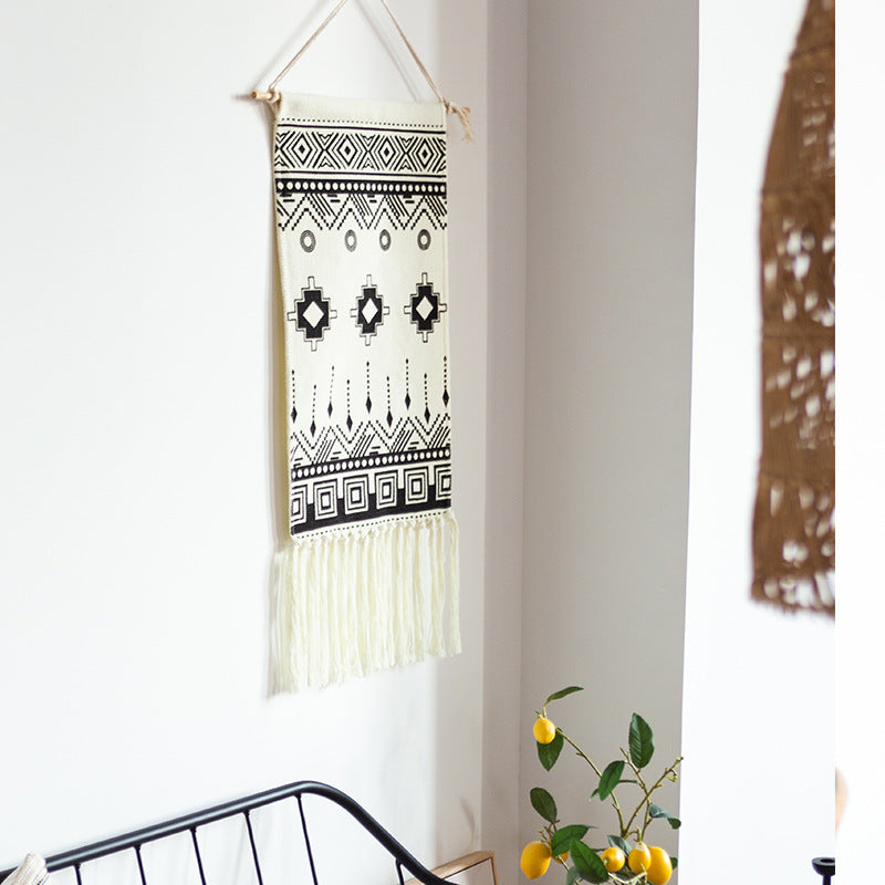 Woven cotton blend wall hanging with graphic ethnic pattern and long fringes