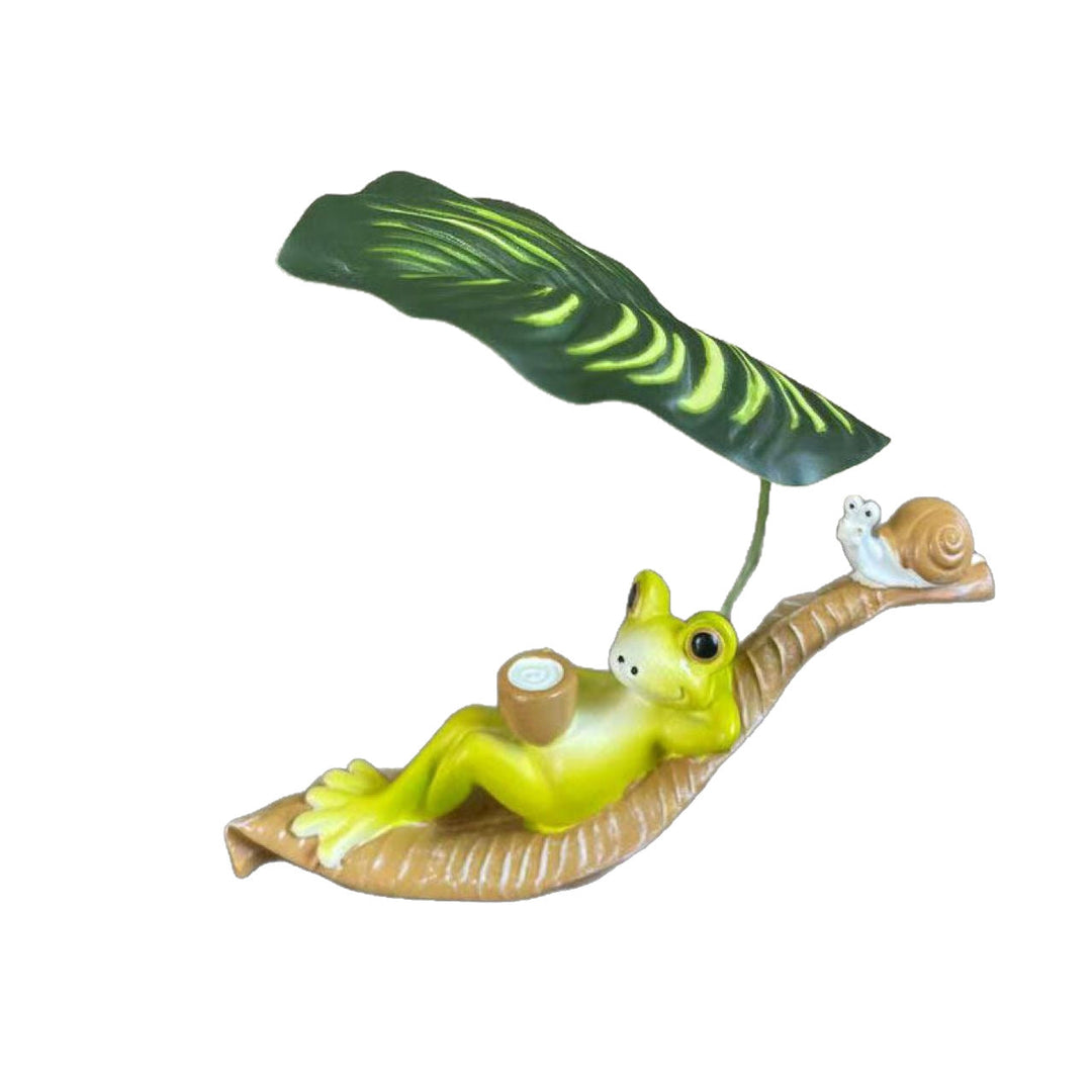 Funny frog figure with leaf decor