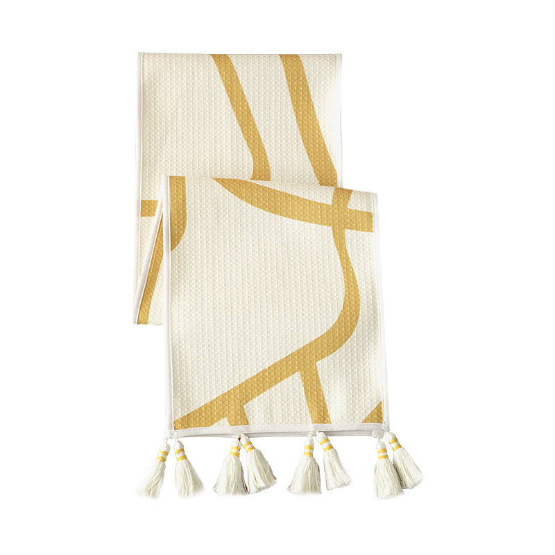Light waffle texture throw blanket with geometric print and tassels