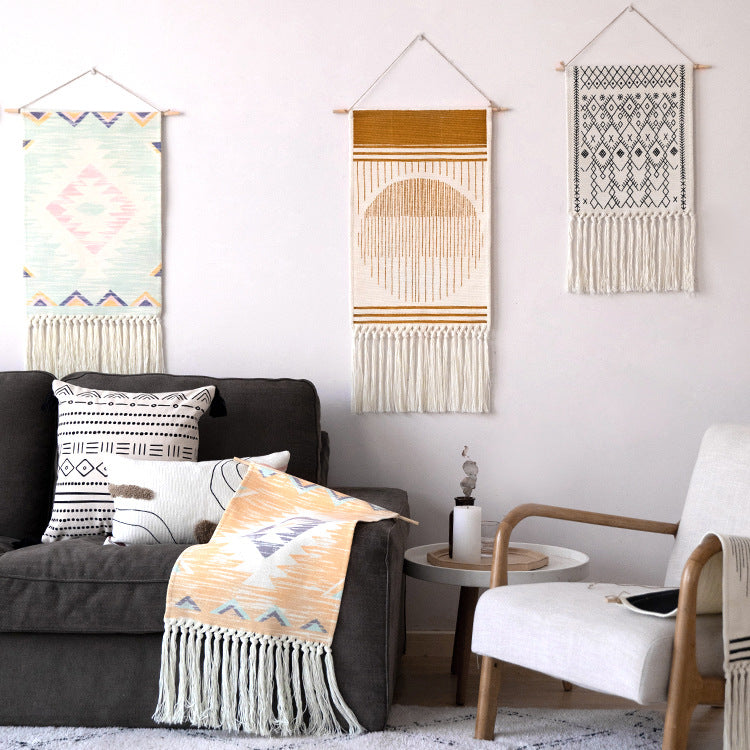Woven Boho wall tapestry in Ethno design with long fringes and wood stick