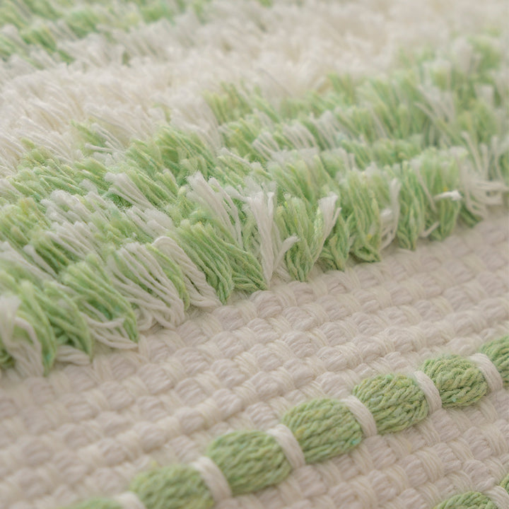 Square decorative cushion with boucle stripes, woven texture, and corner tassels