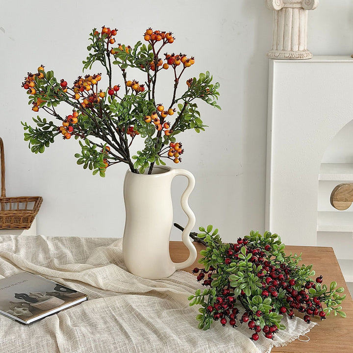 Artificial branch with glowing berries and green