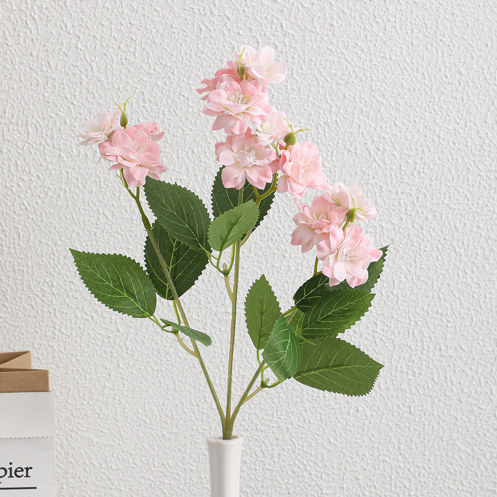 Artificial flower arrangement with delicate white blooms