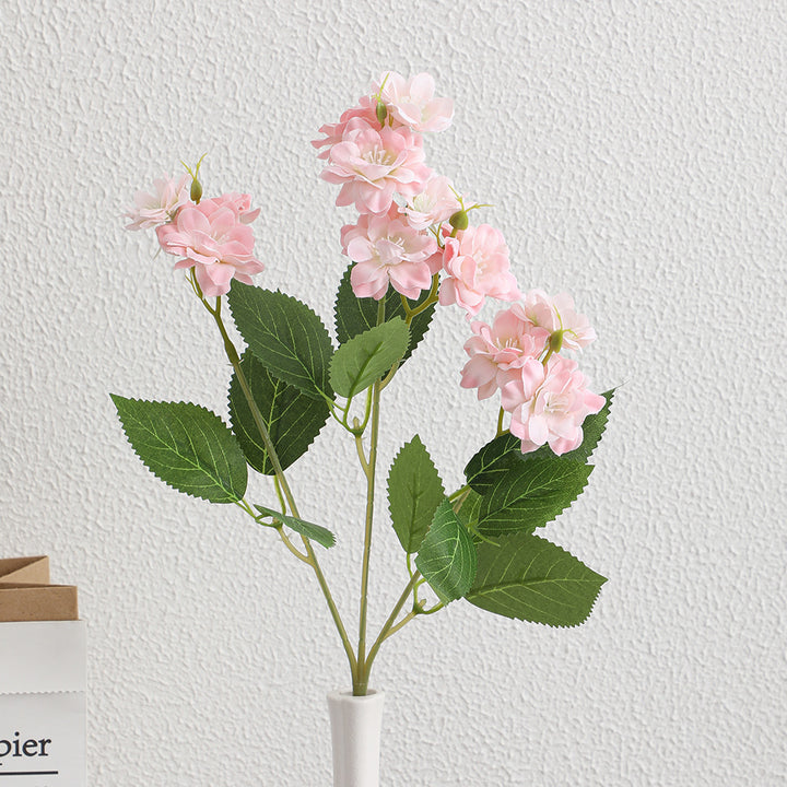 Artificial flower arrangement with delicate white blooms