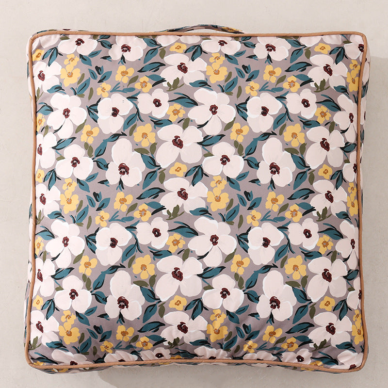 Large square floor cushion with floral cotton cover, piping, and carrying handle