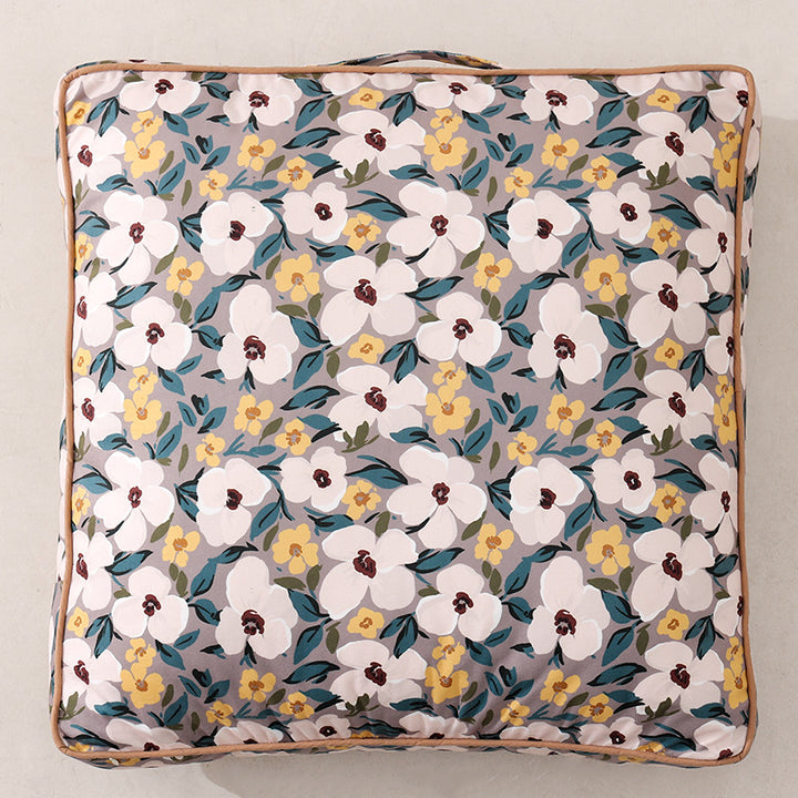 Large square floor cushion with floral cotton cover, piping, and carrying handle