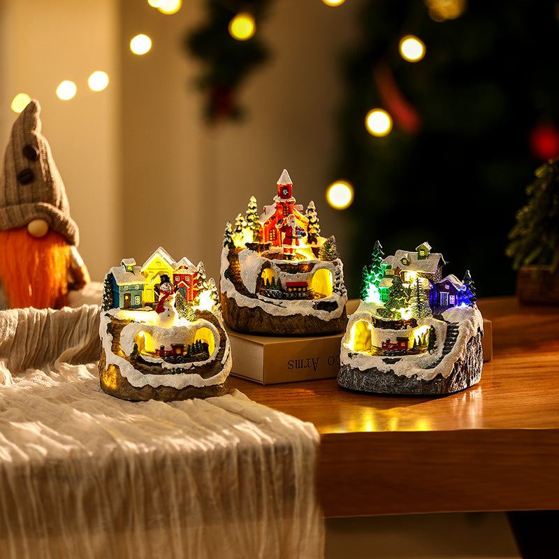 Illuminated Christmas village scene with snowman
