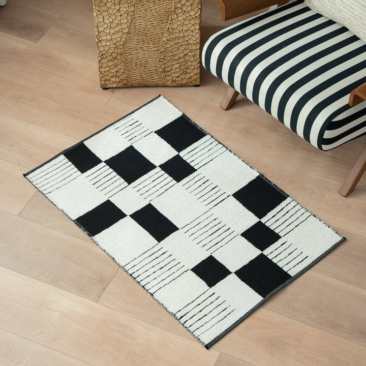 Modern runner rug with graphic checkerboard pattern and short pile structure