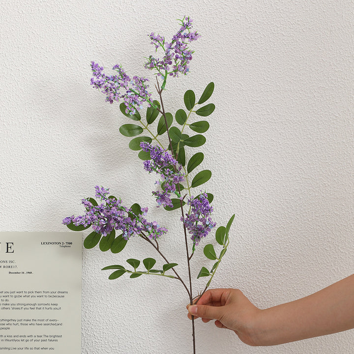 Artificial flower branch with vibrant purple flowers