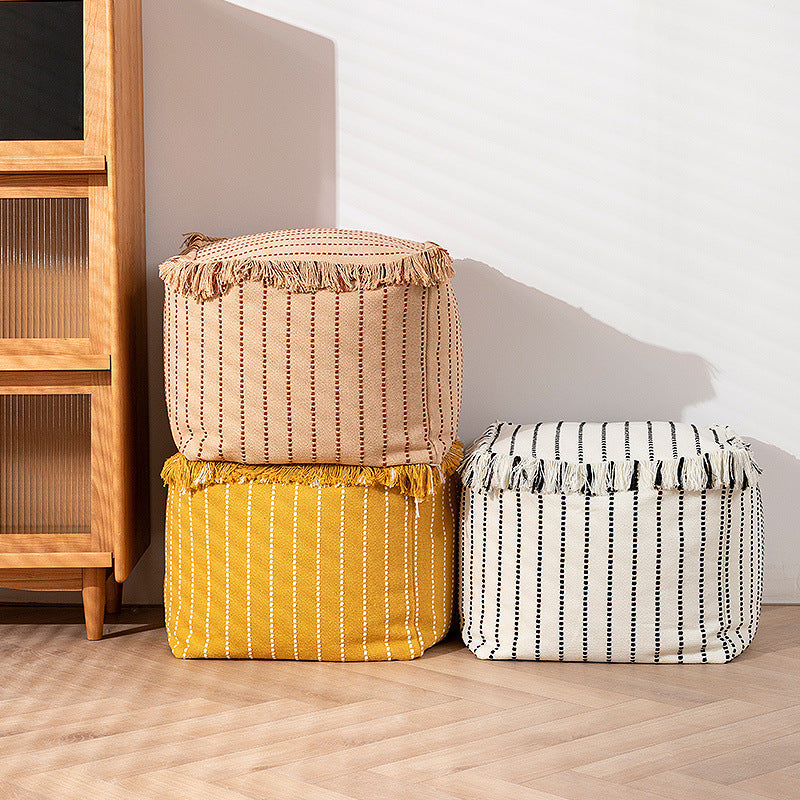 Woven decorative pouf with fringes and structured striped look
