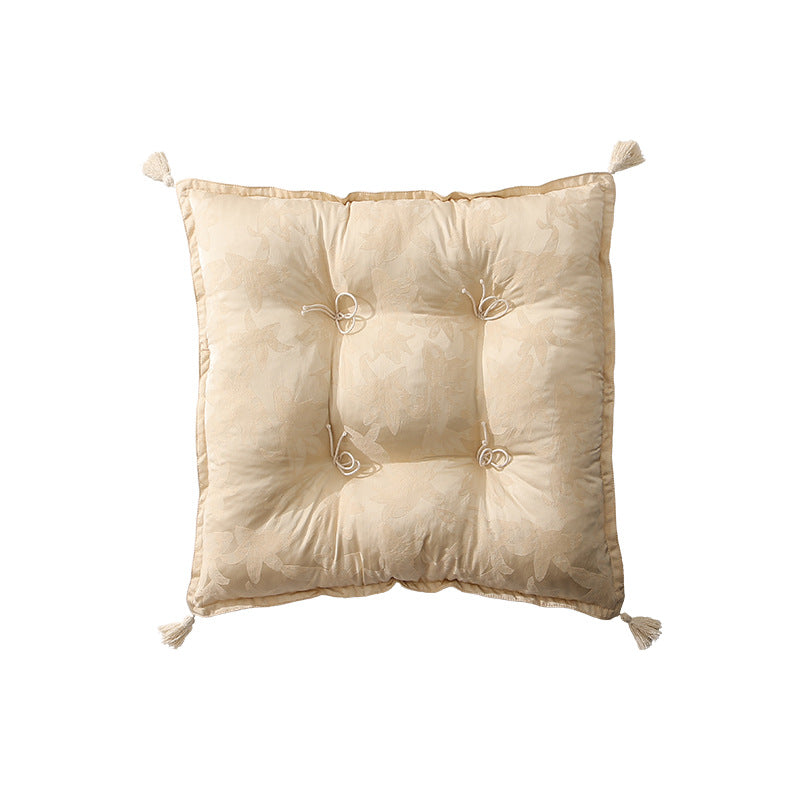 Padded floor cushion with quilted tufting and tassels