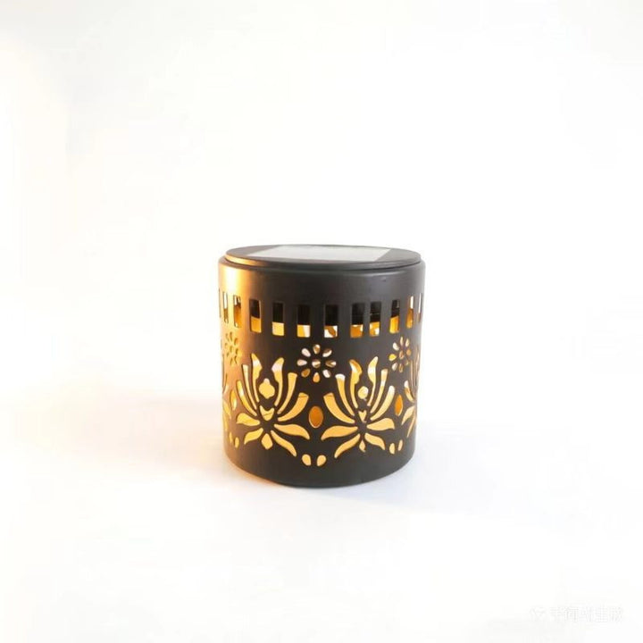 Decorative filigree metal tealight lantern with reflective inner lining