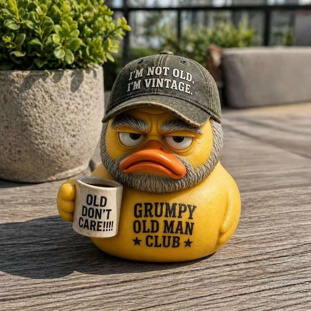 Funny rubber duck with vintage hat and cup