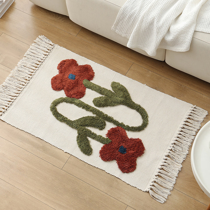 Handwoven cotton bath mat rug with tufted flower appliqué and tassels