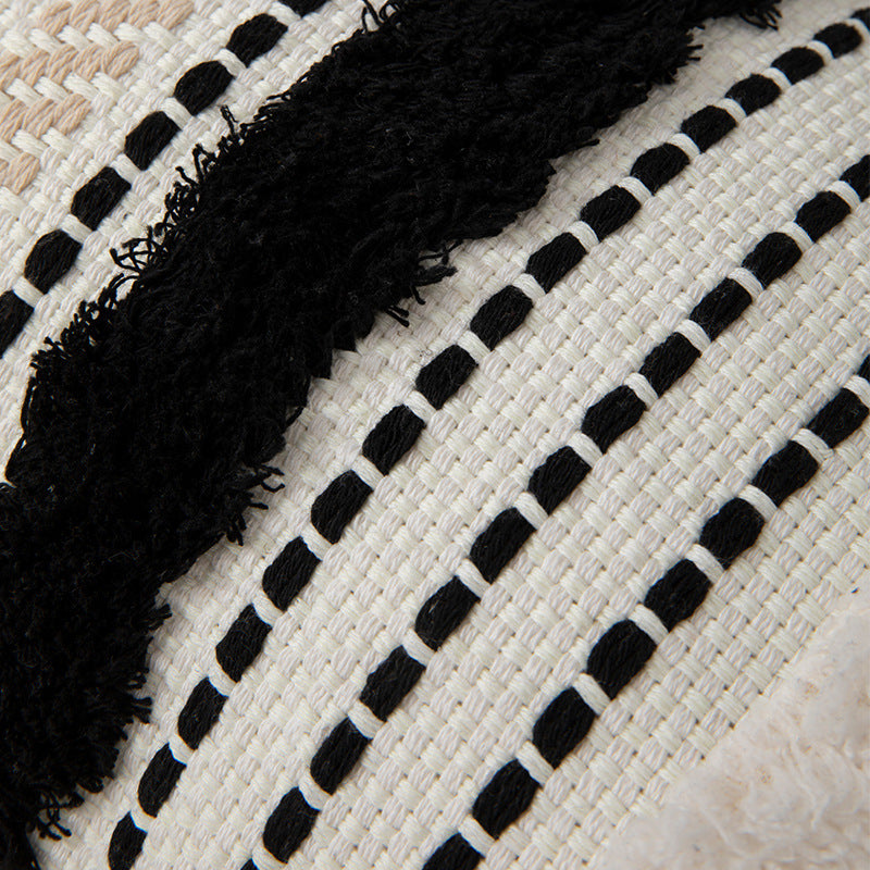 Handwoven decorative cushion cover made of cotton blend with tassels and structured stripe look