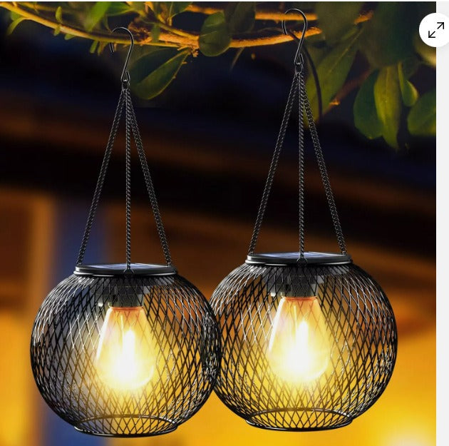 Weatherproof hanging solar LED lanterns for outdoor use with metal cage, warm glass, and hanging chain