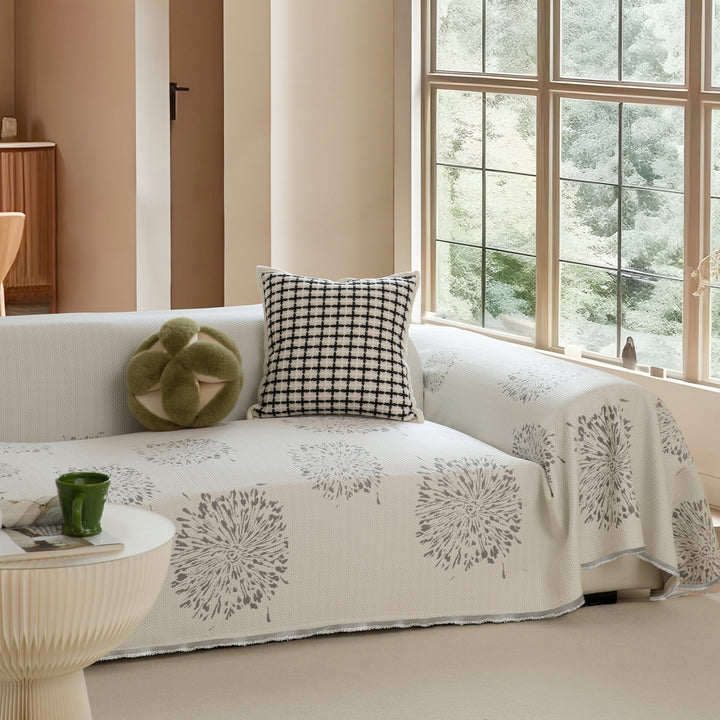 Geometric sofa cover made of cotton blend fabric with decorative fringe edge