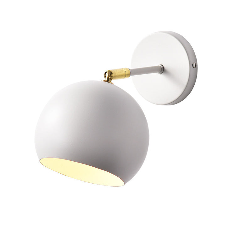 Adjustable matte metal globe wall lamp with brass pivot arm