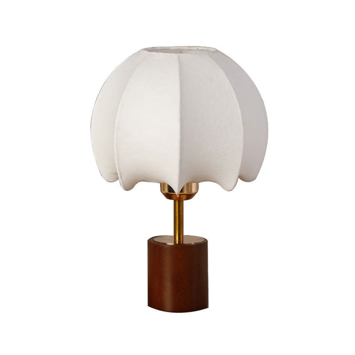 Sculptural table lamp with wooden base, brass stem, and cardboard shade