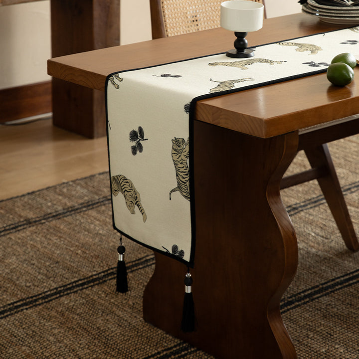 Woven cotton-linen table runner with tiger print and decorative tassels