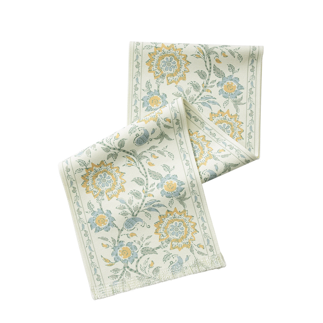 Woven decorative table runner with floral medallion borders and fringes