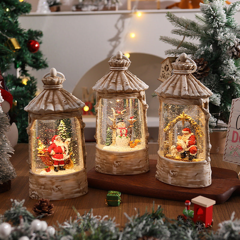 Illuminated Christmas lantern with snow scenes