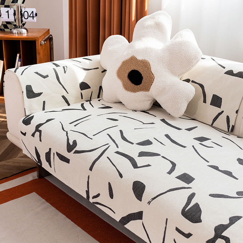 Stretch sofa cover with abstract brushstroke print and elastic waistband
