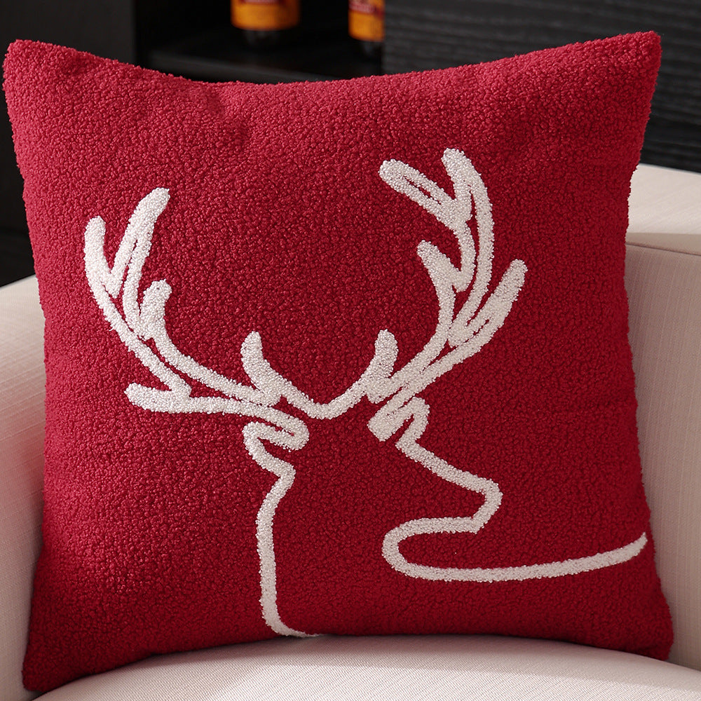 Decorative cushion cover with festive Christmas star print and pom-pom trim