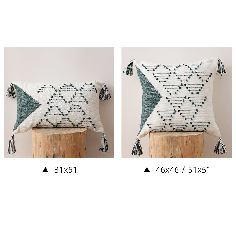 Decorative woven cushion cover with geometric tuft-relief and tassels