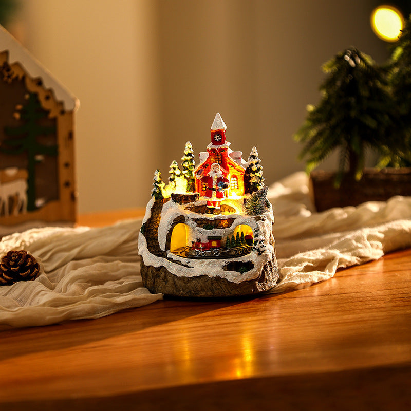 Illuminated Christmas village scene with snowman
