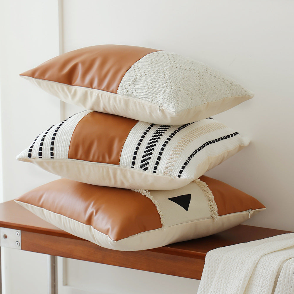 Decorative cushion cover made of faux leather with woven ethnic stripe