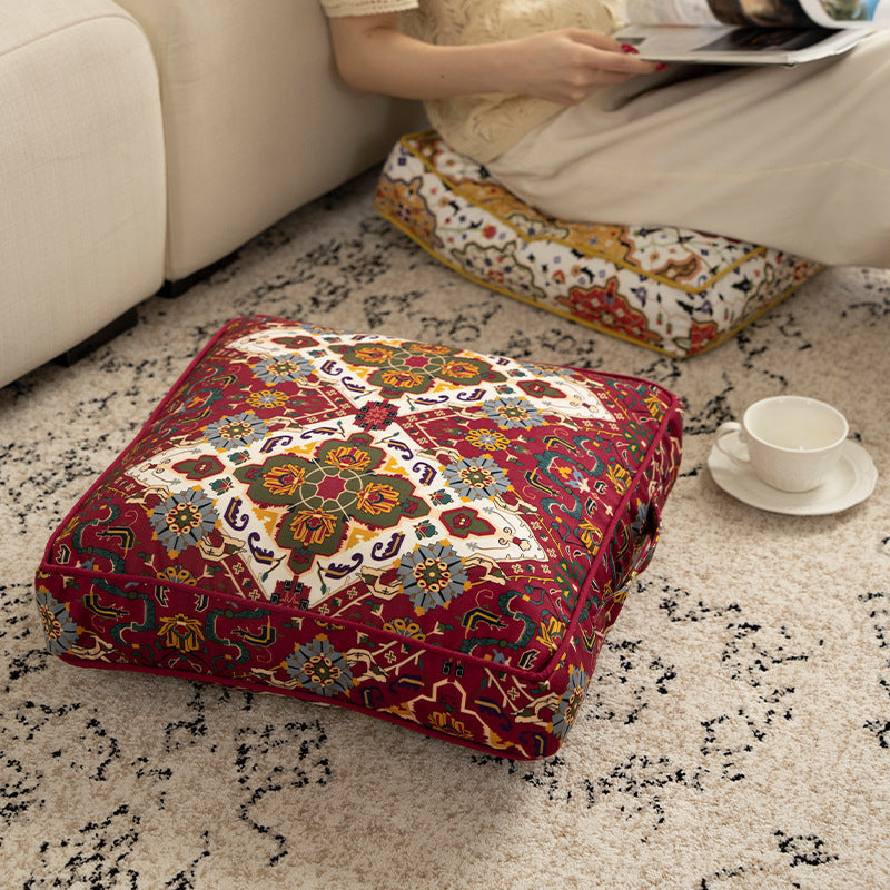 Square decorative cushion with oriental medallion print, piping and carrying handle