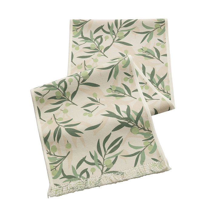 Woven table runner with floral jacquard pattern and fringed edge