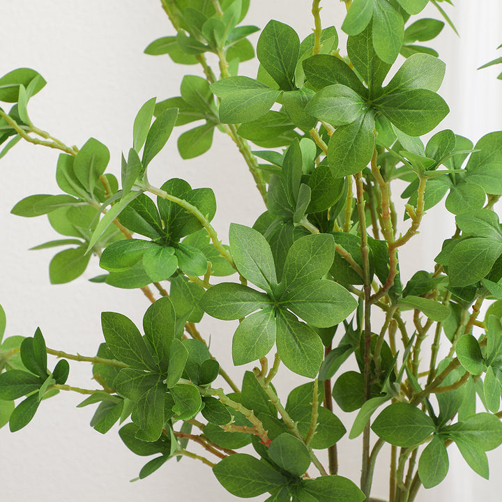 Decorative artificial branch with vibrant leaves