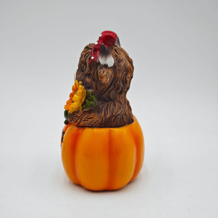 Funny decorative figure of a Highland cow in pumpkin costume