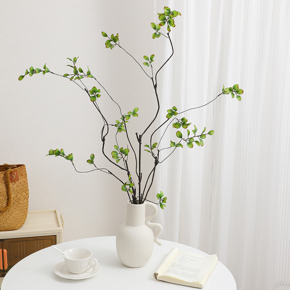 Artificial flower branch with vibrant orange flowers