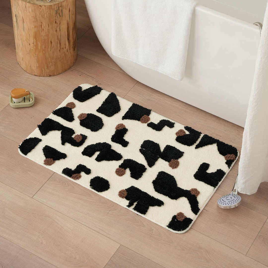 Tufted bathroom mat in abstract leopard pattern with soft high pile