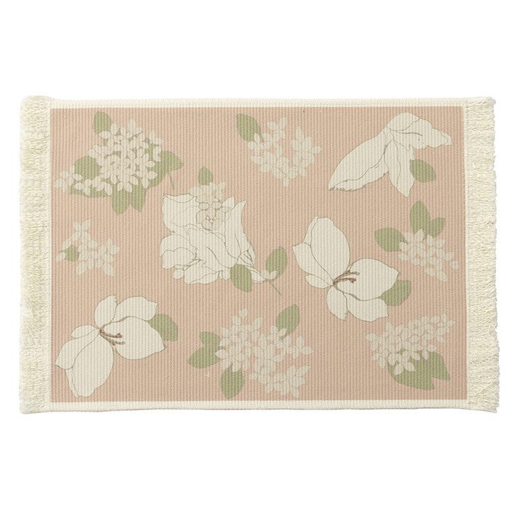 Floral woven bath mat with decorative fringes